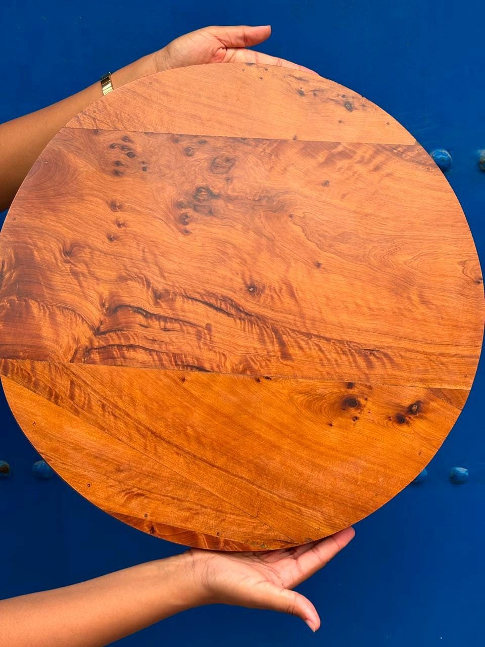 Detail of a hand-set geometric mandala inlay on a thuya wood serving tray, made by Mana Atelier