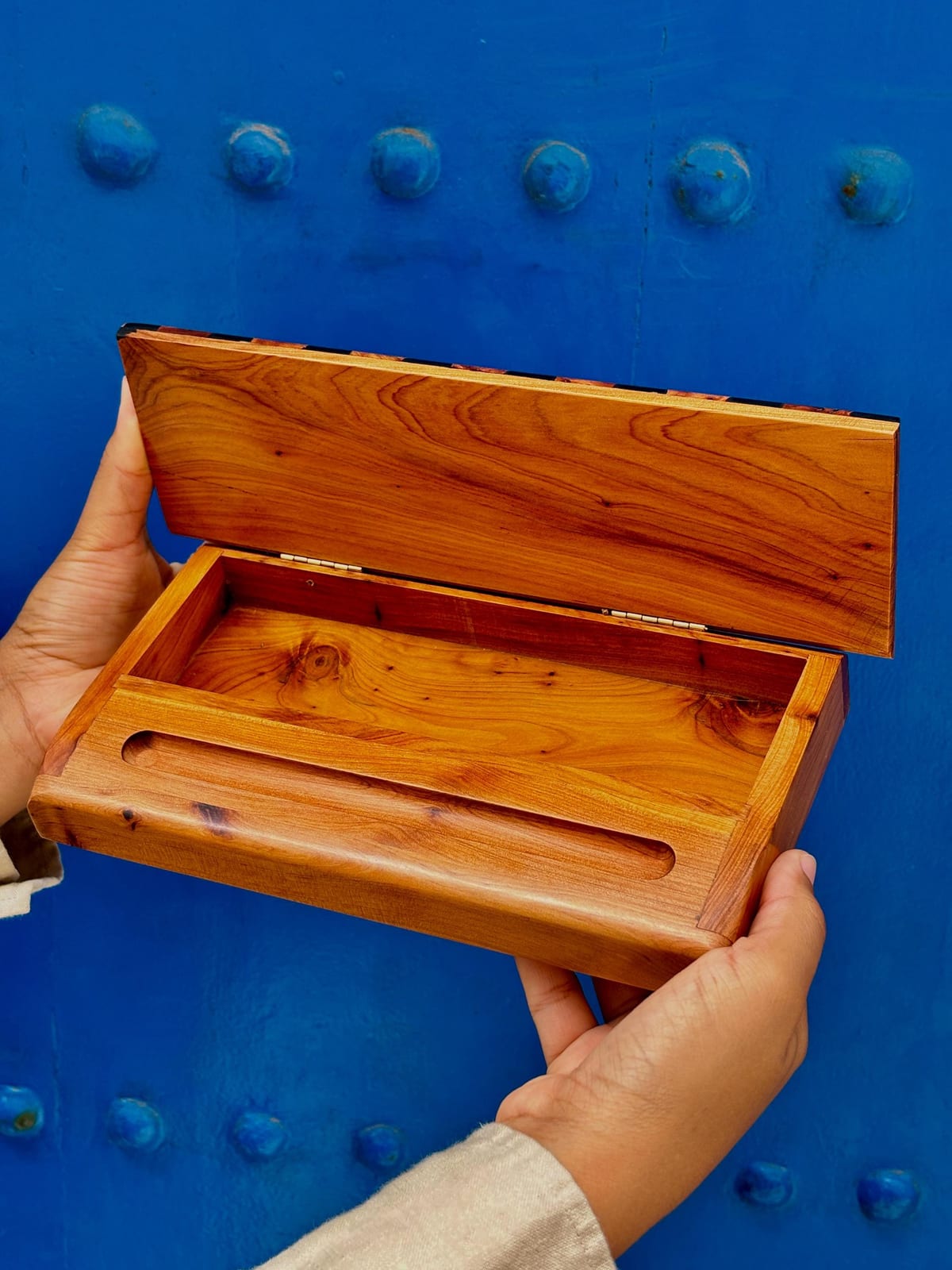 Open thuya wood pencil case showing the hand-finished interior and sliding lid mechanism